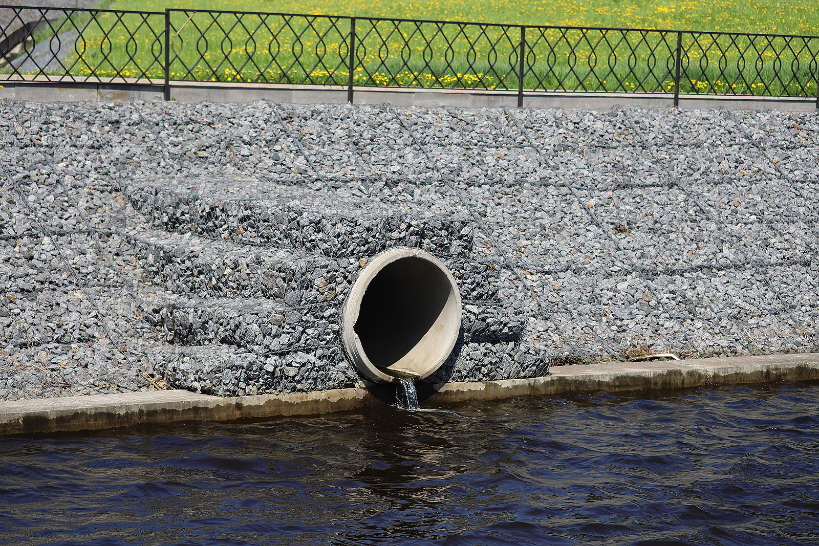 Water Outflows In The River Through Flood Drainage System.