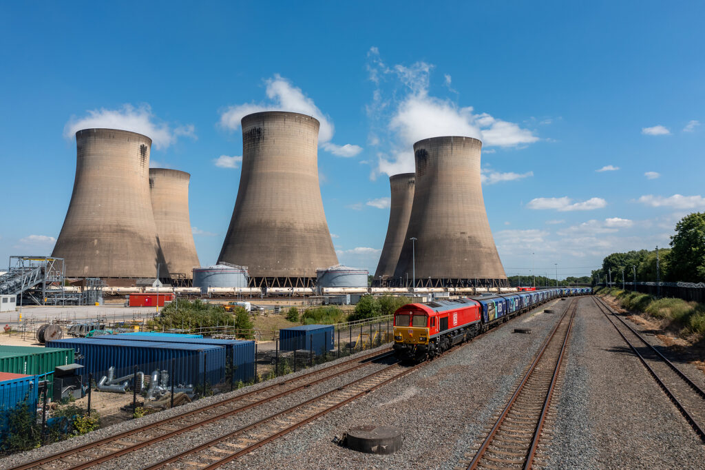 DRAX POWER STATION, UK - JUNE 22, 2022. Aerial view of a freight train and wagons delivering renewable biomass fuel instead of coal to Drax Power Station in the UK to reduce air pollution and emissions